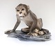 Dahl Jensen. Porcelain figure. Monkey on plinth. Model 1086. Length 21 cm. 
Height 15 cm. (1 quality)